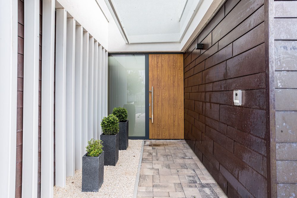 Schüco-alumínium-bejárati-ajtó-szárnyra-lemezelt-faerezet-porszórás-fogantyú-üveg-építészet-minimal-house-kültér-exterior-3